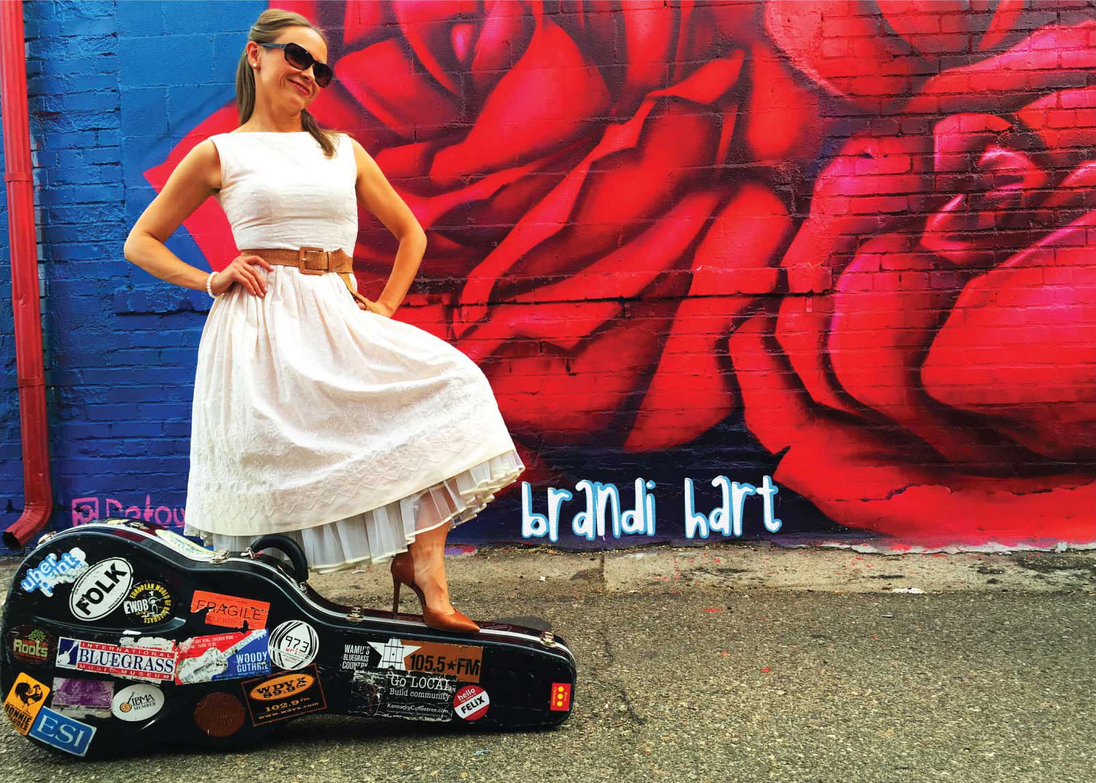 Brandi Hart standing on a guitar case in Denver's RiNo district