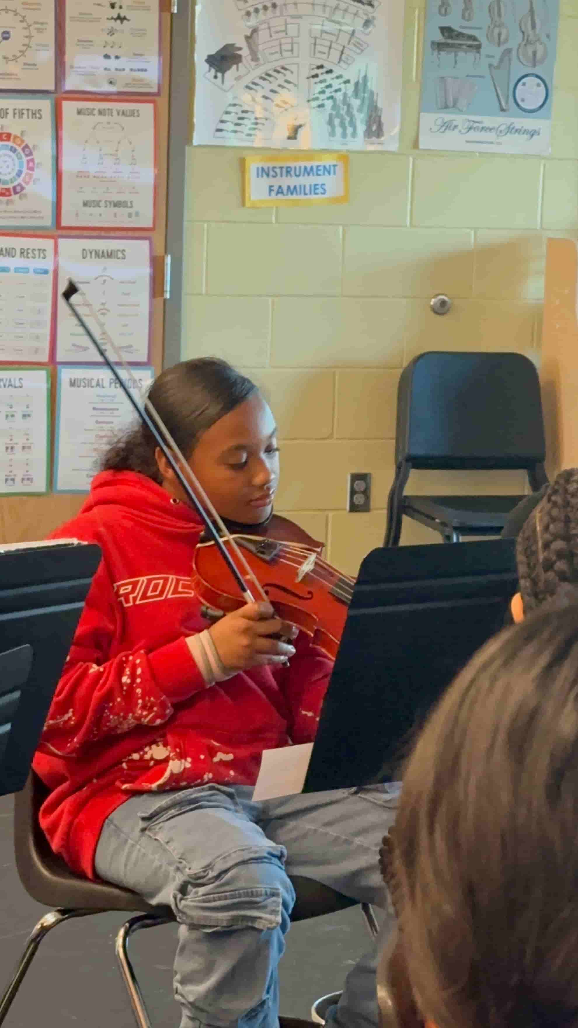Student playing violin during Brandi Hart musical enrichment workshop