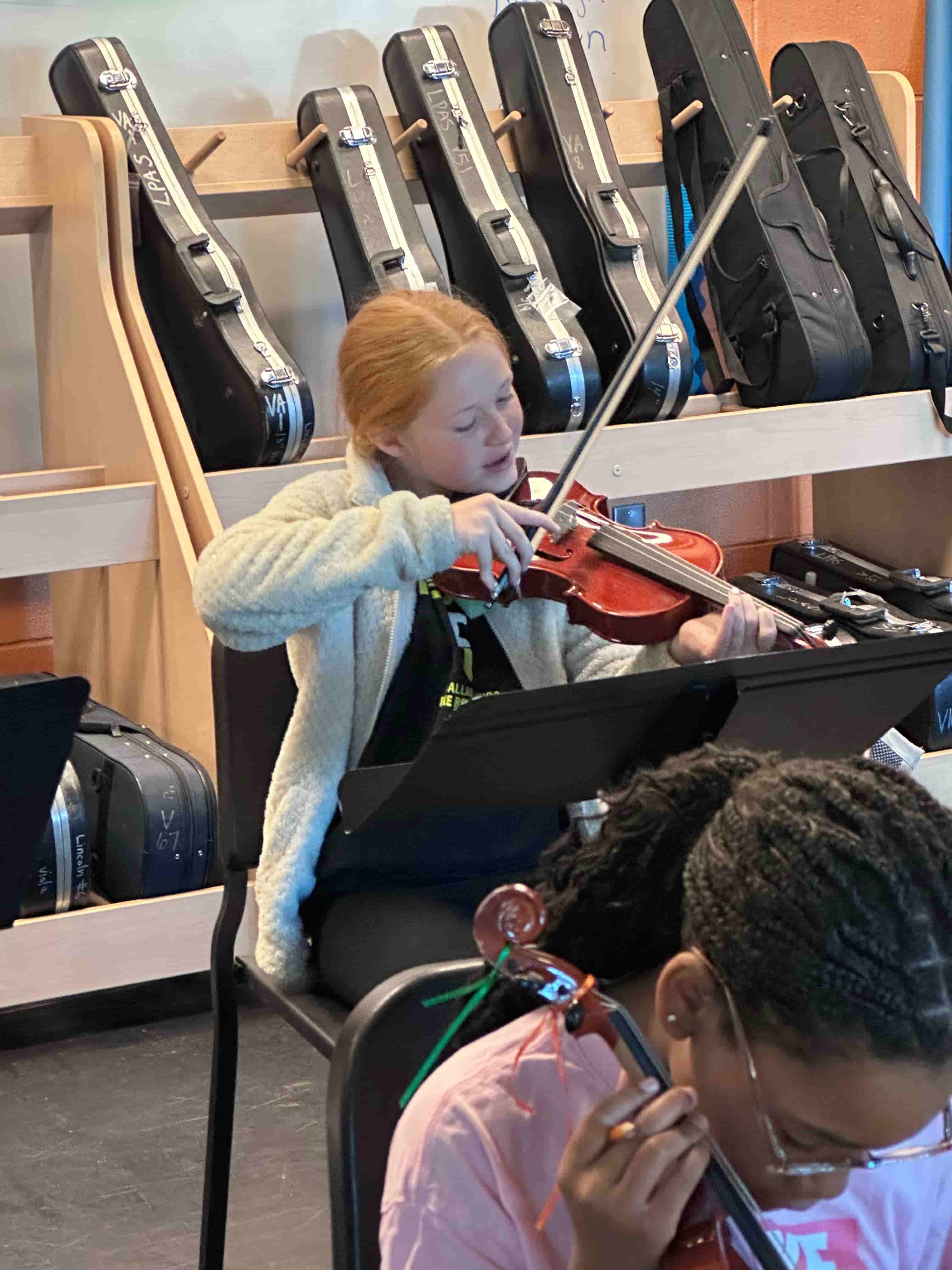 Student playing violin during Brandi Hart musical enrichment workshop